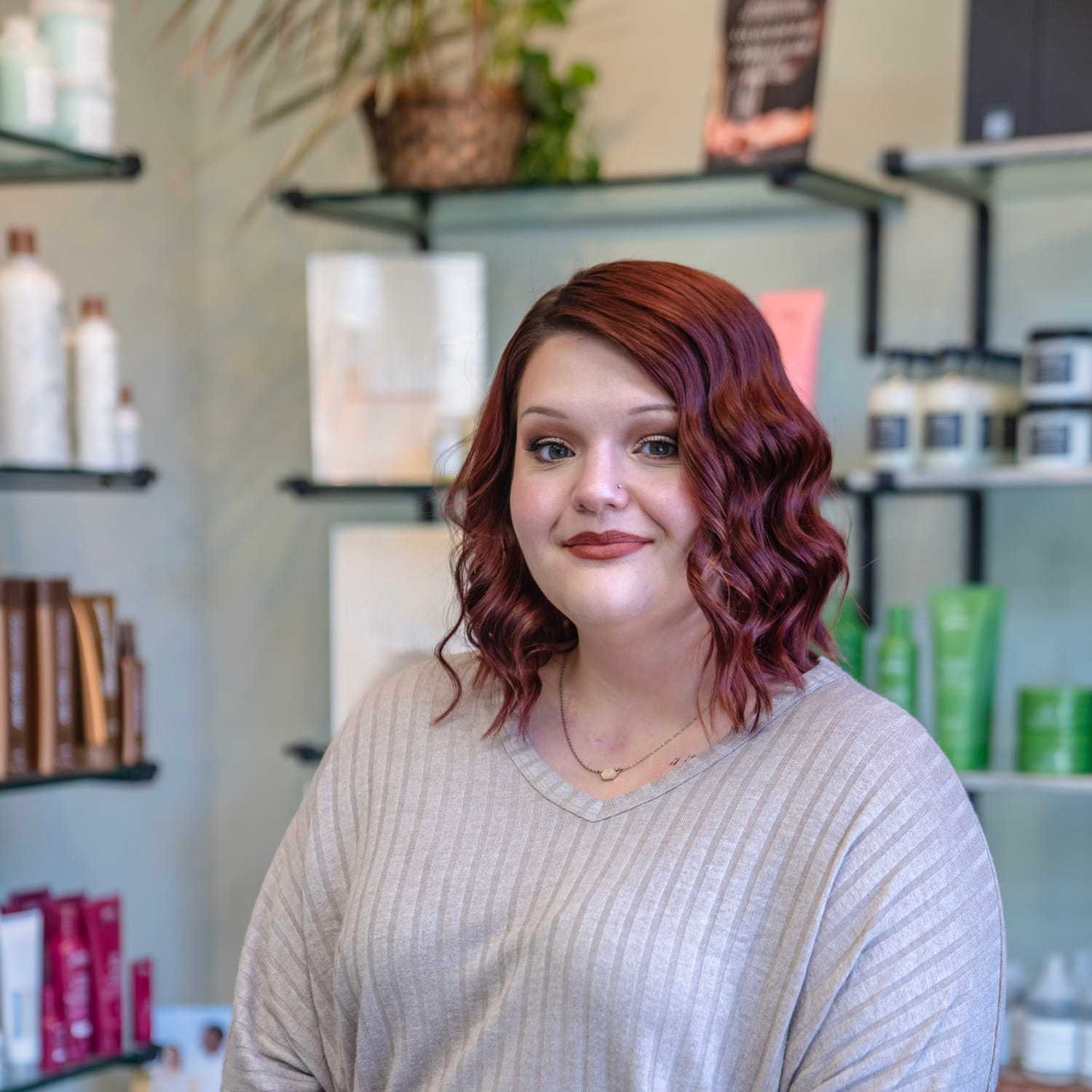 Portrait of Bre, a professional stylist at Salon Sublime, showcasing their expertise and style.