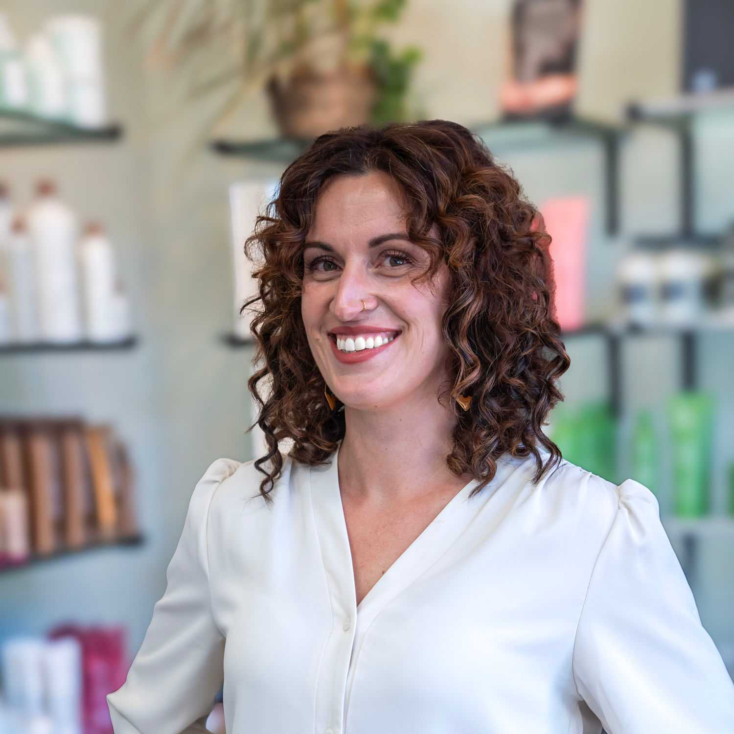 Portrait of Kayla, a professional stylist at Salon Sublime, showcasing their expertise and style.