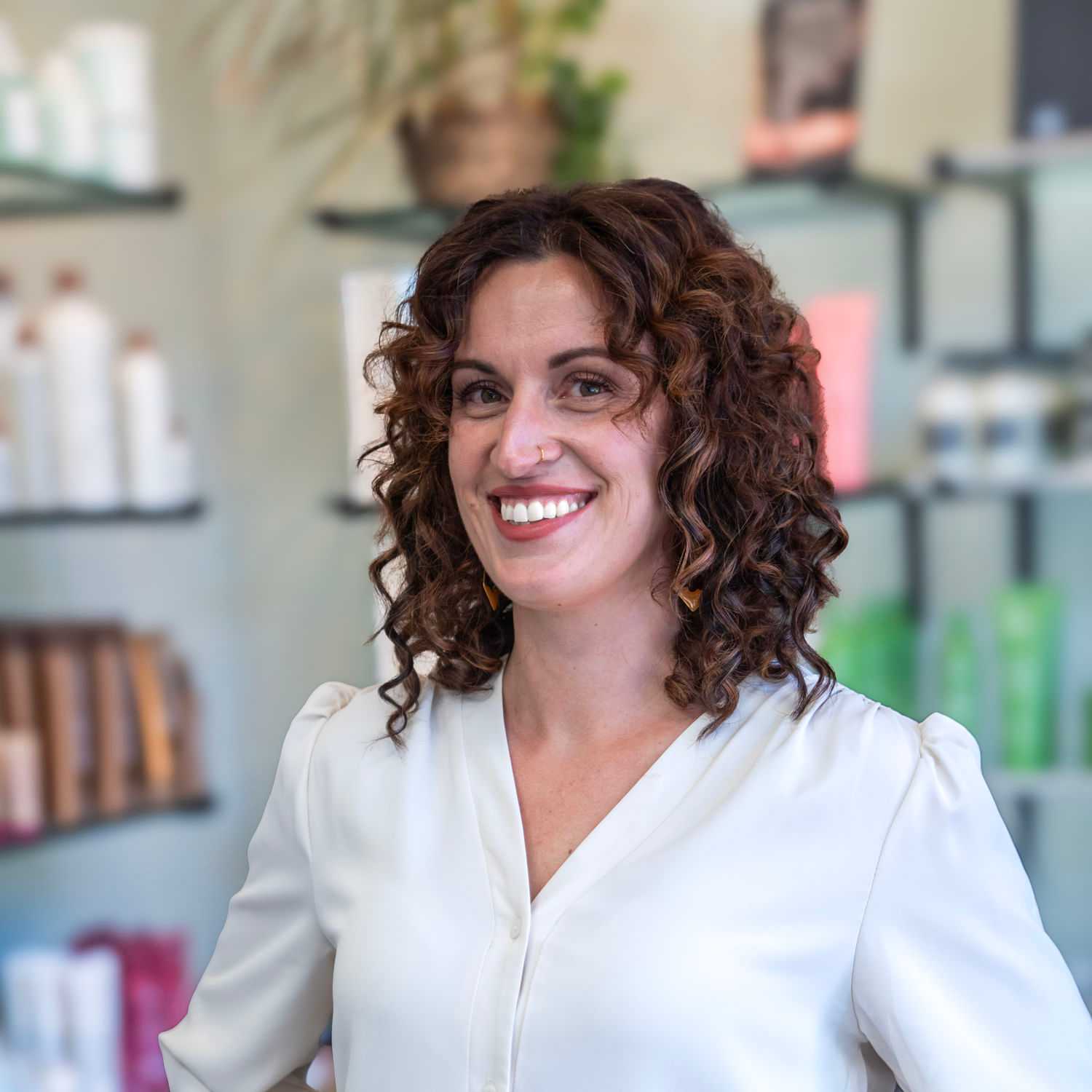 Portrait of Kayla, a professional stylist at Salon Sublime, showcasing their expertise and style.